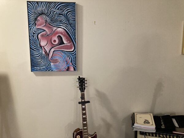 A guitar and painting in the corner of a room.